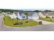 Well-manicured lawn surrounds the light blue home with a palm tree and white fencing at 252 Heath Dr., Longs, SC 29568