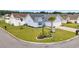 Aerial view of a home with manicured lawn, palm tree, and white fencing in a quiet neighborhood at 252 Heath Dr., Longs, SC 29568