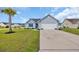 Charming single-story home with a two-car garage and a well-maintained lawn with mature palm tree at 252 Heath Dr., Longs, SC 29568