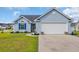 Charming light blue home with a two-car garage, well-manicured lawn, and inviting curb appeal at 252 Heath Dr., Longs, SC 29568