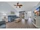 Cozy living room with wood floors, ceiling fan, and sliding glass doors to the outside patio at 252 Heath Dr., Longs, SC 29568
