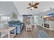 Inviting living room with wood floors, blue sofa, ceiling fan, and fireplace for relaxing by the television at 252 Heath Dr., Longs, SC 29568