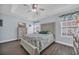 Stylish main bedroom with hardwood floors, tray ceiling, and soft, neutral colors at 252 Heath Dr., Longs, SC 29568