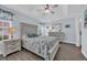 Serene main bedroom featuring hardwood floors, tray ceiling, and soft, neutral colors at 252 Heath Dr., Longs, SC 29568