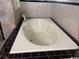 Bathroom featuring a large jacuzzi tub with black tile trim at 2862 Loblolly Ave., Little River, SC 29566