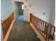 Hallway with wood railing and carpeted floor at 2862 Loblolly Ave., Little River, SC 29566