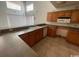 Well-lit kitchen featuring wood cabinets, tile floor, and updated appliances at 2862 Loblolly Ave., Little River, SC 29566