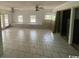 Bright open living room with tile floors, multiple windows and ceiling fans at 2862 Loblolly Ave., Little River, SC 29566