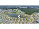 Aerial view of homes in a lakeside community surrounded by a lush green forest at 3078 Gillham Loop, Myrtle Beach, SC 29588