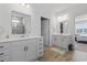 Spacious bathroom featuring double vanities, wood-look flooring, and a glass enclosed shower at 3078 Gillham Loop, Myrtle Beach, SC 29588