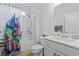 Stylish bathroom features a shower with colorful curtain, wood-look tile floor, and modern fixtures at 3078 Gillham Loop, Myrtle Beach, SC 29588