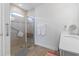 Accessible bathroom featuring a glass-enclosed shower with a bench and grab bar at 3078 Gillham Loop, Myrtle Beach, SC 29588
