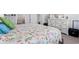 Comfortable bedroom showcasing a beautifully patterned quilt and white dresser at 3078 Gillham Loop, Myrtle Beach, SC 29588