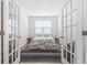 Bedroom featuring a striped rug and a cozy bed with a quilt, viewed through open french doors at 3078 Gillham Loop, Myrtle Beach, SC 29588