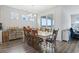 Bright dining room with hardwood floors, a large table, and views of the lake from the sliding glass doors at 3078 Gillham Loop, Myrtle Beach, SC 29588