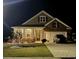 Inviting home with warm lighting, lush landscaping, and a welcoming front entrance at night at 3078 Gillham Loop, Myrtle Beach, SC 29588