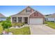 Charming brick home with a two-car garage, a landscaped front yard, and decorative shutters at 3078 Gillham Loop, Myrtle Beach, SC 29588