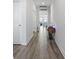 Bright hallway with hardwood floors leading to a living area, adorned with decorative touches at 3078 Gillham Loop, Myrtle Beach, SC 29588