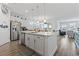 Open kitchen featuring a large island with granite countertops, stainless appliances, and hardwood floors at 3078 Gillham Loop, Myrtle Beach, SC 29588
