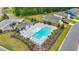 Aerial view of a pristine community pool area with ample seating and a modern pool house at 3078 Gillham Loop, Myrtle Beach, SC 29588