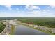 Aerial view showcases the community's homes, lake, and wooded surroundings at 3573 Bells Lake Circle, Longs, SC 29568