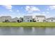 A scenic view of the lake, lawns, and the rear of the homes at 3573 Bells Lake Circle, Longs, SC 29568