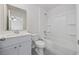 Bathroom with white tub/shower and vanity with gray tile flooring and a mirror at 3573 Bells Lake Circle, Longs, SC 29568
