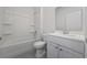 Clean bathroom with tub and shower, a white sink and vanity, and a tiled floor at 3573 Bells Lake Circle, Longs, SC 29568