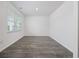 Bright, empty bedroom features durable floors, crisp white trim, and a sunny window with blinds at 3573 Bells Lake Circle, Longs, SC 29568