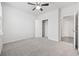 Comfortable bedroom featuring a ceiling fan, carpeted floors, and a convenient closet with an open door at 3573 Bells Lake Circle, Longs, SC 29568