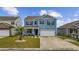 Charming home featuring blue siding, lush lawn, and a two-car garage at 3573 Bells Lake Circle, Longs, SC 29568