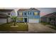 Charming two-story home with blue siding, dark shutters, well-manicured lawn and a two car garage at 3573 Bells Lake Circle, Longs, SC 29568