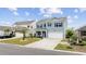 Charming two-story home with blue siding, dark shutters, well-manicured lawn and a two car garage at 3573 Bells Lake Circle, Longs, SC 29568