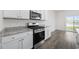 Updated kitchen with stainless steel appliances, granite countertops, white cabinetry and durable floors at 3573 Bells Lake Circle, Longs, SC 29568