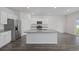 Eat-in kitchen with island, granite countertops, stainless steel appliances, and durable floors at 3573 Bells Lake Circle, Longs, SC 29568