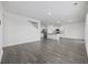 Spacious living room features an open floor plan with hardwood floors and a modern kitchen in the background at 3573 Bells Lake Circle, Longs, SC 29568