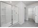 Modern glass enclosed shower with tiled walls and floor plus open doorway to another room at 3573 Bells Lake Circle, Longs, SC 29568