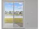 A sliding glass door offers exterior view of the lush green backyard, and a tranquil pond at 3573 Bells Lake Circle, Longs, SC 29568