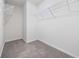 This walk-in closet has white wire shelving, carpet, and neutral colored walls at 3573 Bells Lake Circle, Longs, SC 29568