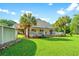 Inviting backyard with well-manicured lawn, palm trees, and a charming patio, ideal for outdoor enjoyment at 3721 Ed Smith Ave., Myrtle Beach, SC 29588