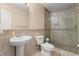 Bright bathroom featuring a pedestal sink, glass-enclosed shower, and tiled flooring at 3721 Ed Smith Ave., Myrtle Beach, SC 29588