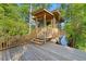 Charming wooden dock featuring a screened-in gazebo and stairs leading to calm, tree-lined waters at 3721 Ed Smith Ave., Myrtle Beach, SC 29588