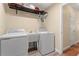 Practical laundry room with a washer, dryer, utility sink, and overhead storage, designed for convenience at 3721 Ed Smith Ave., Myrtle Beach, SC 29588
