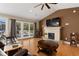 Inviting living room featuring a stone fireplace, ceiling fan, and access to the back deck at 3721 Ed Smith Ave., Myrtle Beach, SC 29588