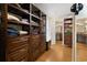 Open walk-in closet featuring custom wood shelving and cabinetry for optimal organization at 3721 Ed Smith Ave., Myrtle Beach, SC 29588