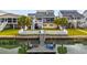 Aerial view of a waterfront home featuring a private dock, fenced yard, and access to a scenic waterway at 39 Newport St., Ocean Isle Beach, NC 28469