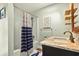 Neutral bathroom with a tub/shower, marble countertop vanity, and tasteful nautical decor at 39 Newport St., Ocean Isle Beach, NC 28469