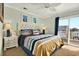 Comfortable bedroom with nautical-themed bedding, a ceiling fan, and access to a private deck at 39 Newport St., Ocean Isle Beach, NC 28469