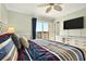 Bright bedroom features striped bedding, neutral walls, ceiling fan, and slider to a private deck at 39 Newport St., Ocean Isle Beach, NC 28469