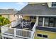 Outdoor seating on a deck under a roof overhang, perfect for enjoying the serene surroundings of this waterfront home at 39 Newport St., Ocean Isle Beach, NC 28469